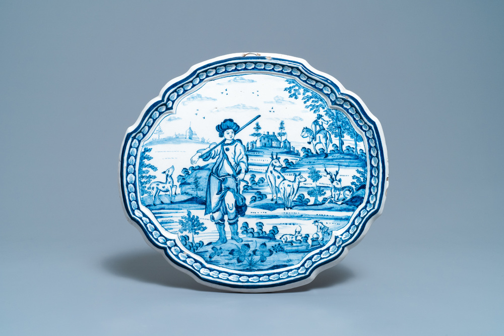 A Dutch Delft blue and white plaque with a hunter, 18th C.