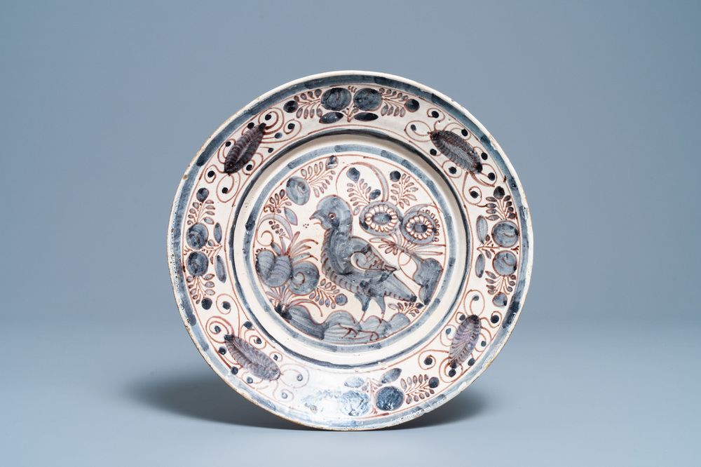 A blue, white and manganese Portuguese faience charger with a bird, 17th C.