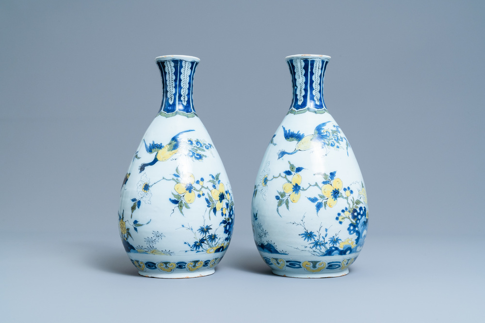 A pair of unusual polychrome Dutch Delft chinoiserie vases with a dragon and birds in a flowery garden, 17th C.