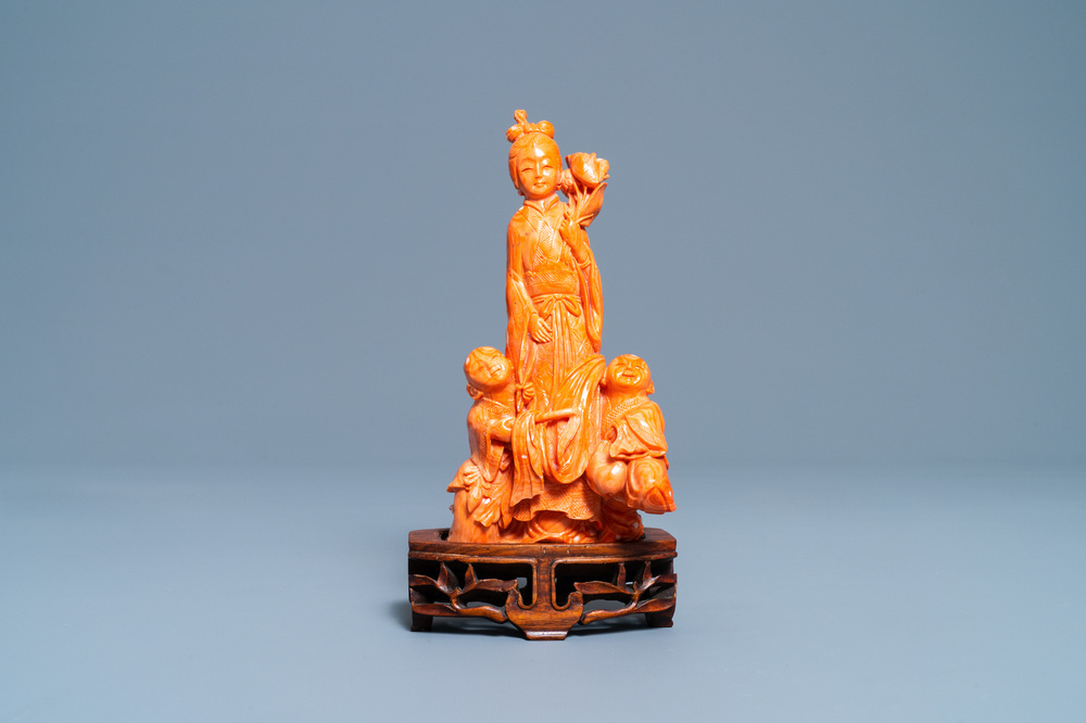 A Chinese carved red coral group of a lady with two boys, 19/20th C.