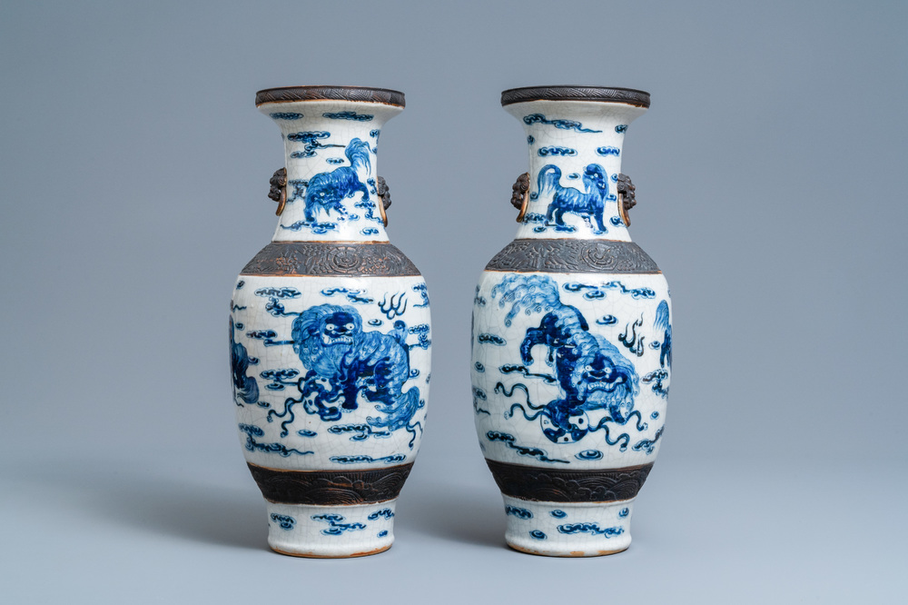 A pair of Chinese blue and white Nanking crackle-glazed vases with Buddhist lions, 19th C.