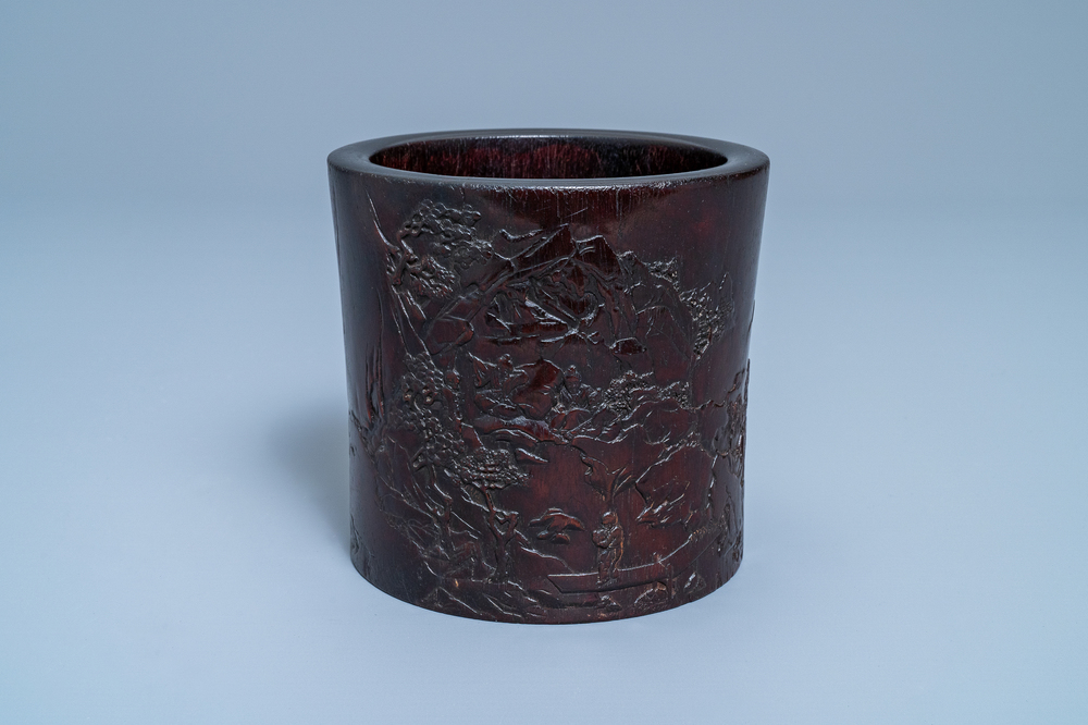 A Chinese carved zitan wood brush pot with a mountainous landscape, 17/18th C.