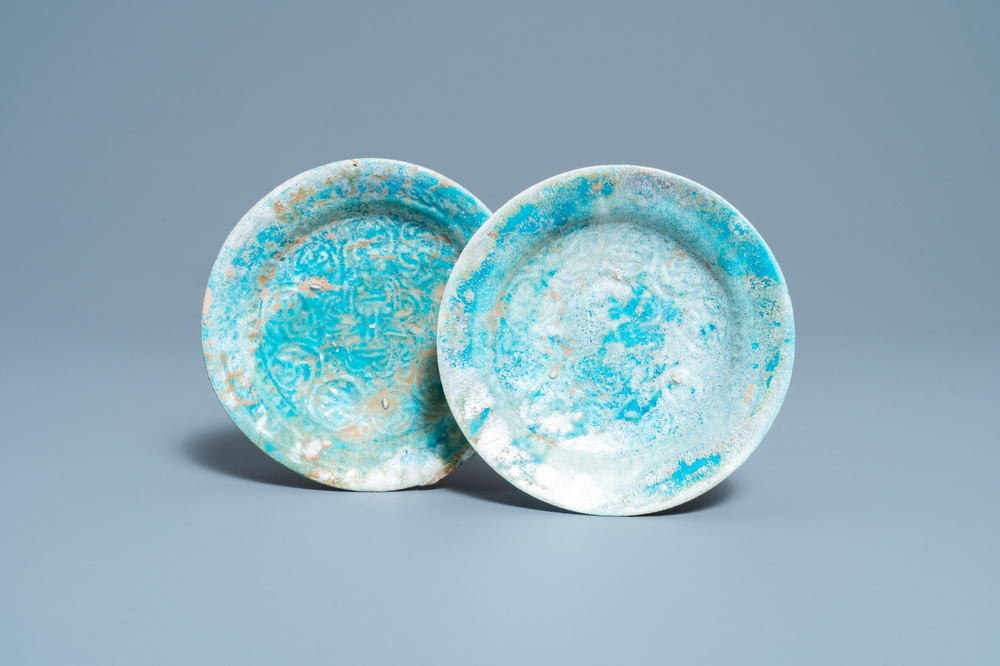 A pair of turquoise-glazed relief-decorated plates, Raqqa, Syria, 13/14th C.