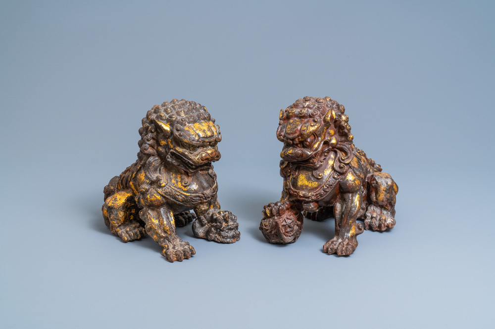 A pair of large Chinese gilt-lacquered iron models of Buddhist lions, 18/19th C.