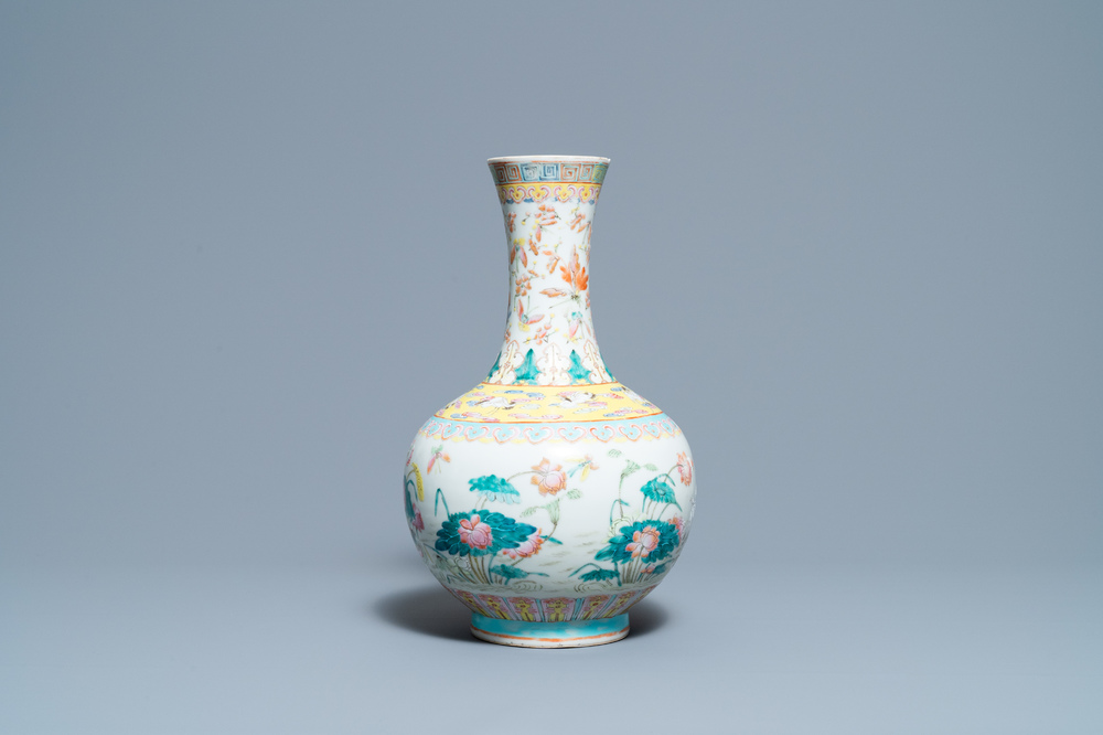 A Chinese famille rose bottle vase with mandarin ducks in a lotus pond, 19th C.