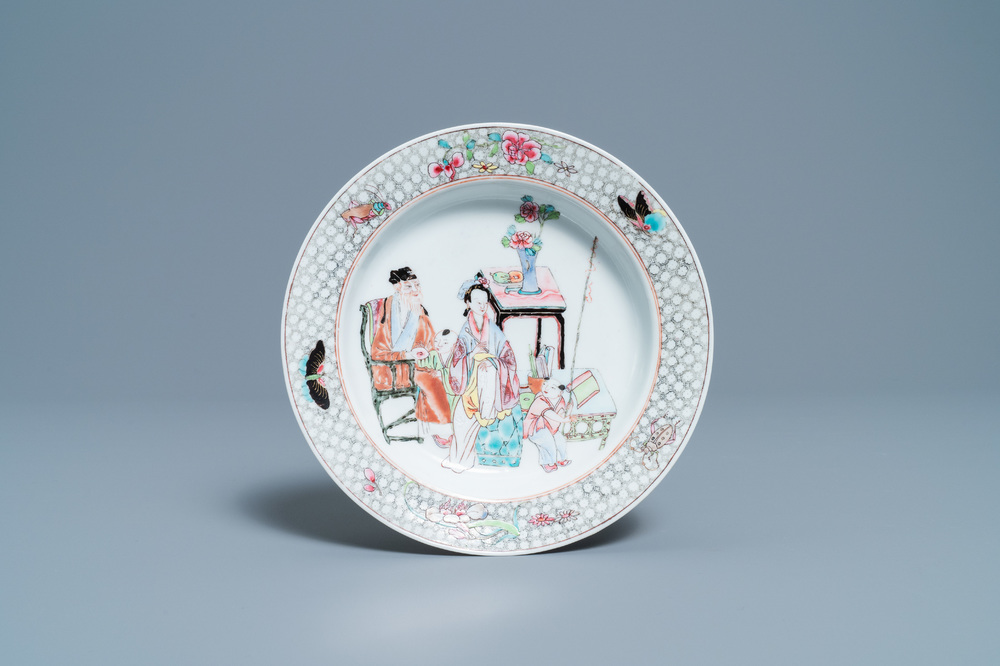 A Chinese famille rose plate with figures in an interior, Yongzheng