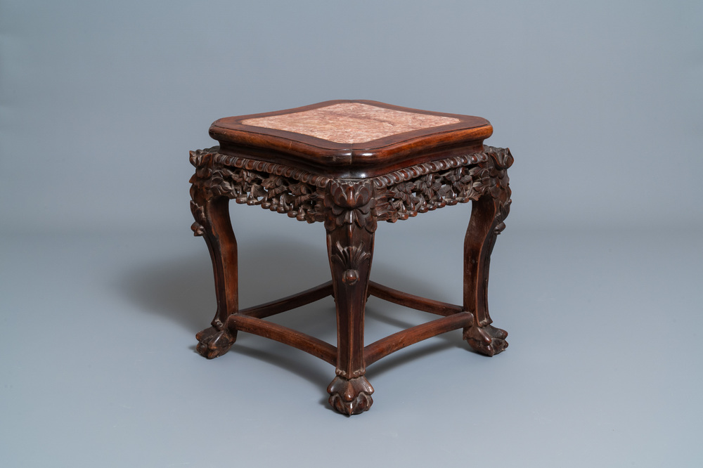 A Chinese carved wooden stand with marble top, 19th C.