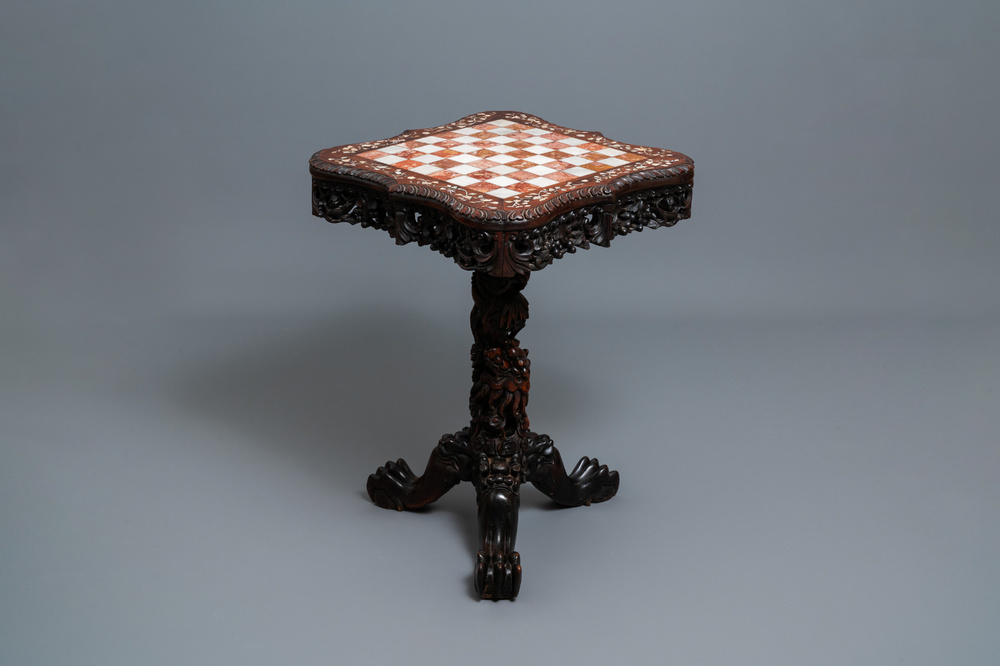 A Chinese carved wooden side table with marble chessboard top, 19th C.