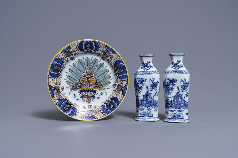 A pair of Dutch Delft blue and white vases and a 'peacock's tail' plate, 18th C.