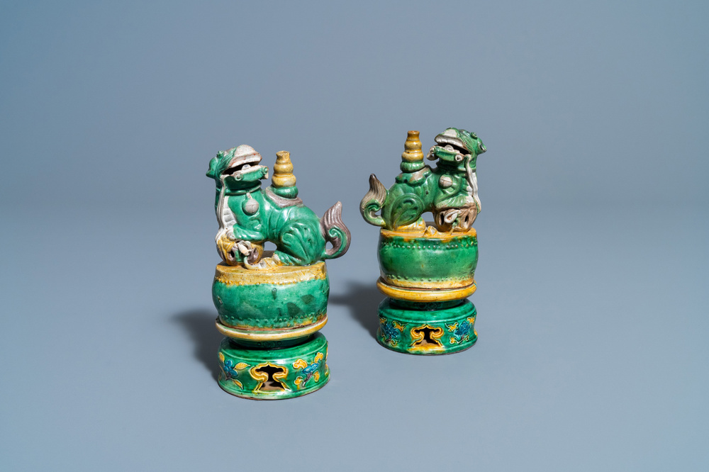 A pair of Chinese sancai-glazed biscuit Buddhist lion joss stick holders, Ming