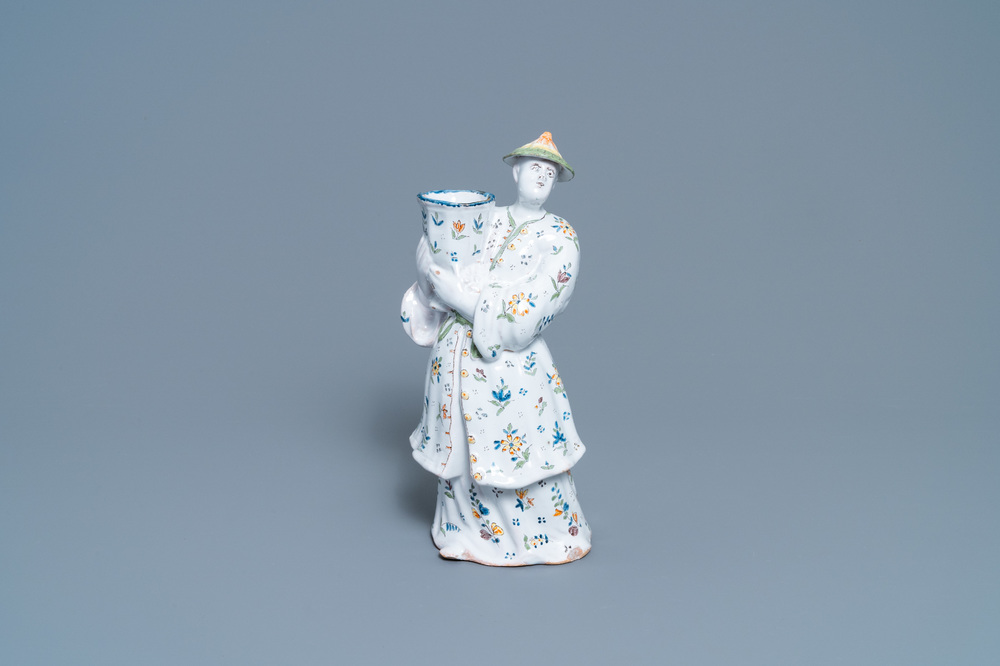 A polychrome French faience candle holder in the shape of a Chinaman, Lille, 18th C.