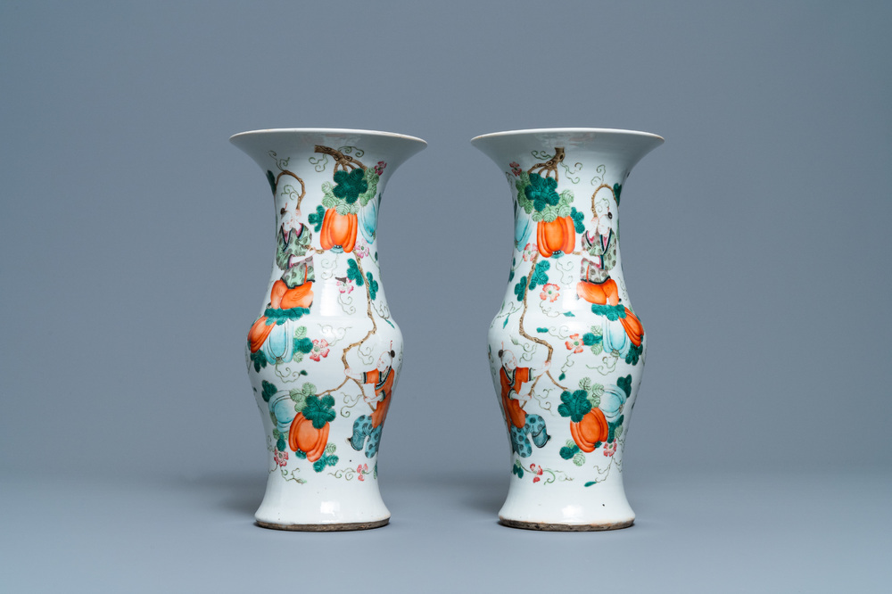 A pair of Chinese famille rose vases with boys hanging near pumpkins, 19th C.