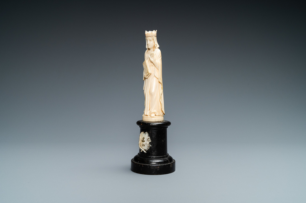 An ivory figure of a female saint holding a book, 19th C.