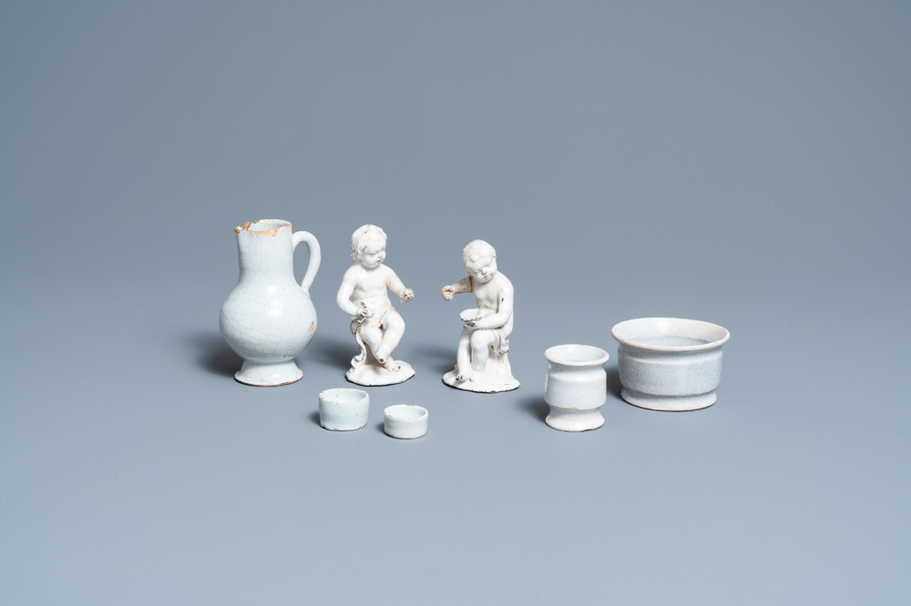 Four white Dutch Delftware ointment jars, a jug and two figures, 17/19th C.