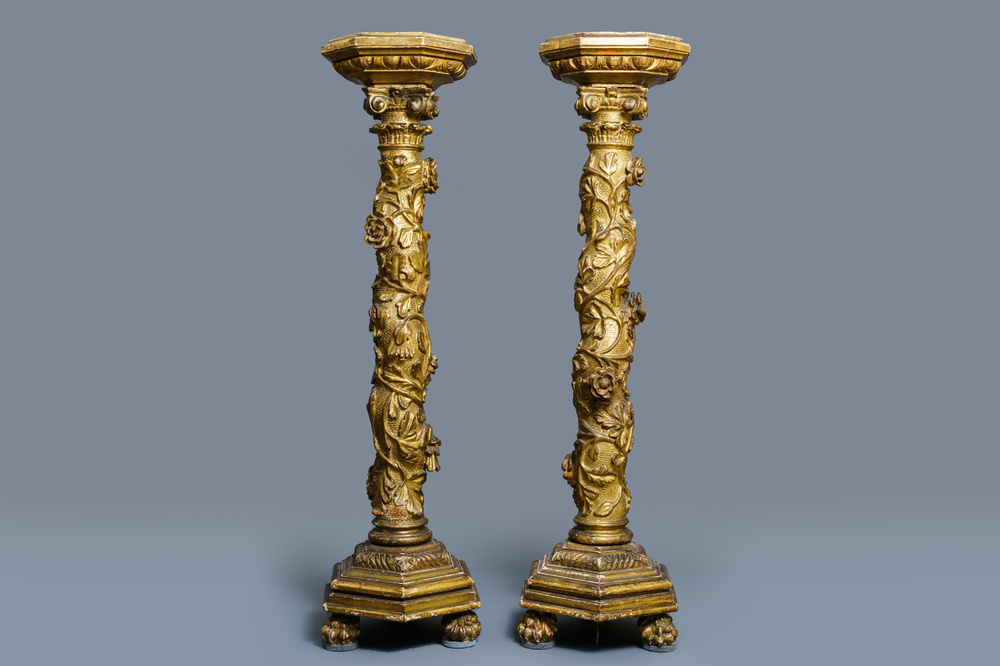 A pair of gilded wooden columns with Ionic capitals, floral swirls and lion paws, Italy, 18th C.