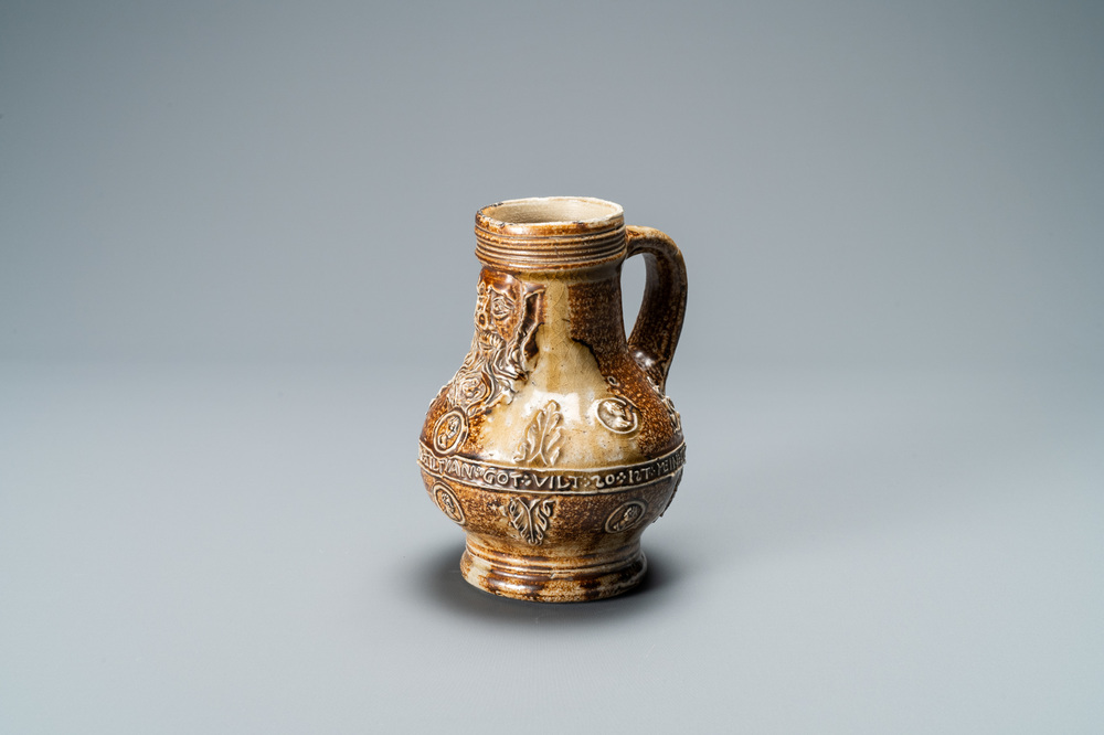 A German stoneware bellarmine jug with a text band and portrait medallions, Frechen, 16th C.