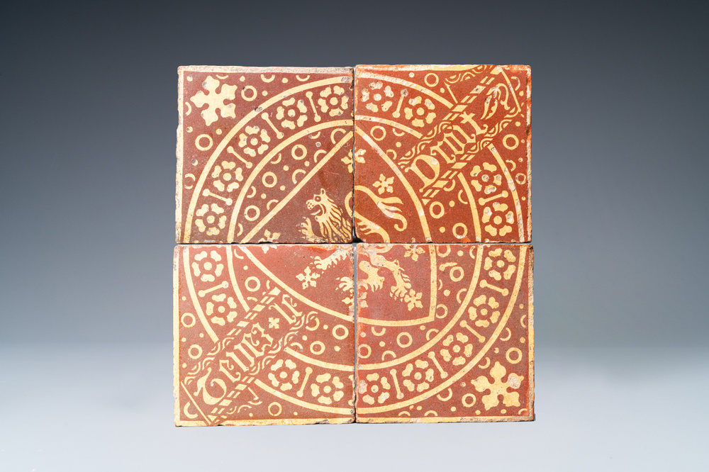 A field of four English encaustic armorial 'Tenez le droit' tiles, 19th C. or older