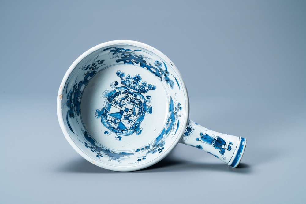 A rare Dutch Delft blue and white warming bowl with the arms of the Austrian von Zinzendorf family, late 17th C.