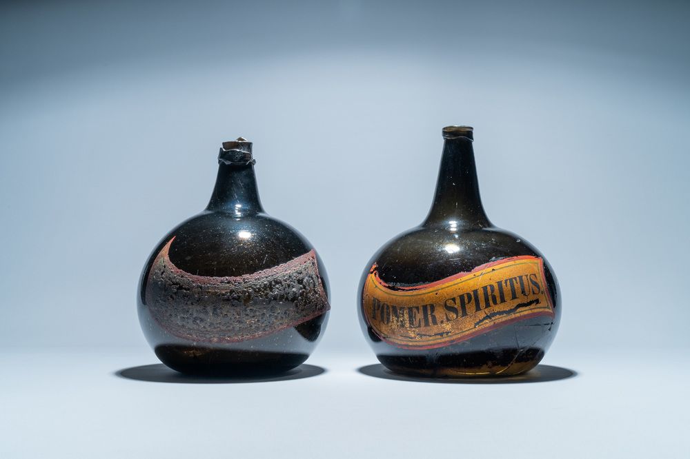 Two large dark green glass bottles with painted inscriptions, 17/18th C.