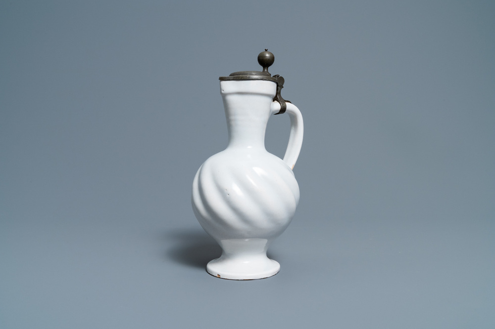 A gadrooned white Dutch Delftware jug with pewter cover, 17th C.