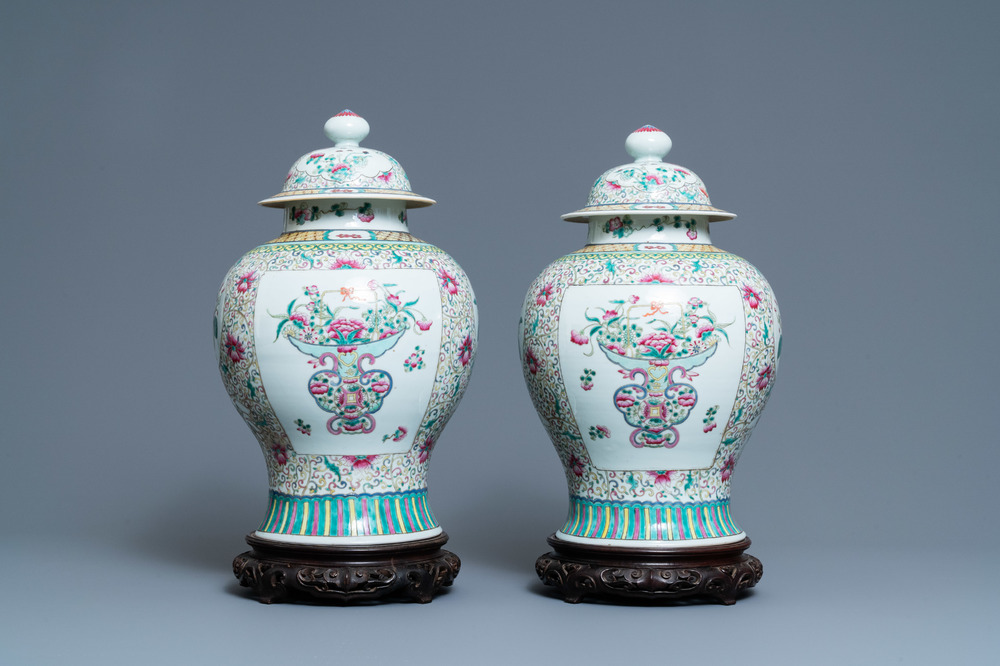 A pair of Chinese famille rose vases and covers, 19th C.