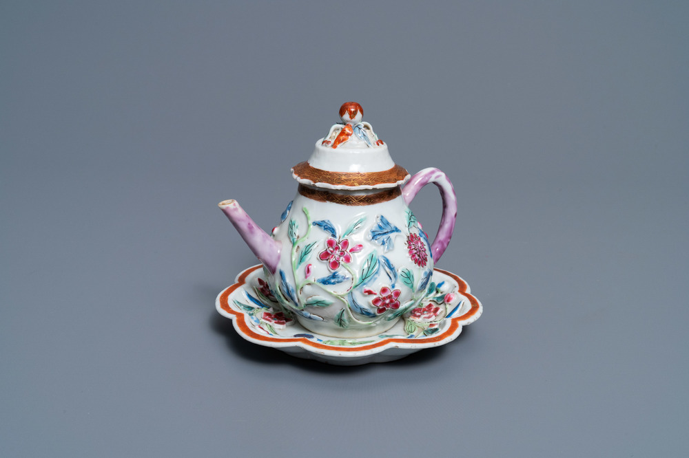 A Chinese famille rose relief-decorated teapot on stand, Yongzheng