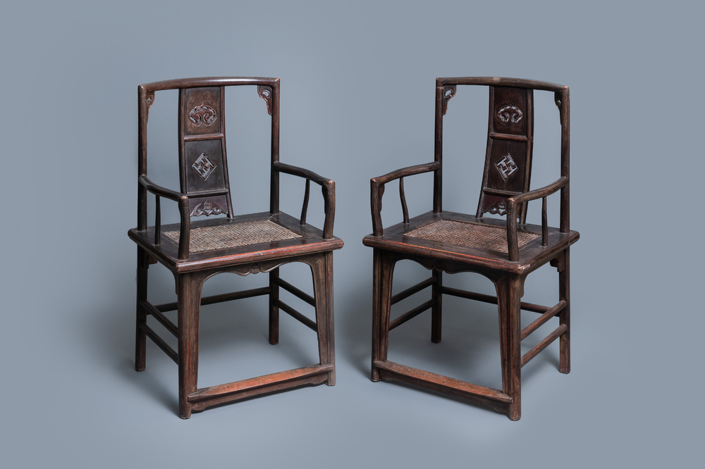 A pair of Chinese carved wooden chairs with wicker seats, 19th C.