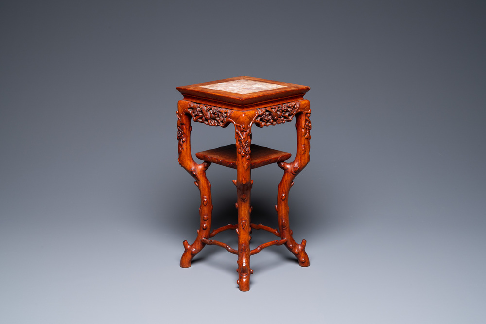 A Chinese carved wooden marble top stand, 19th C.