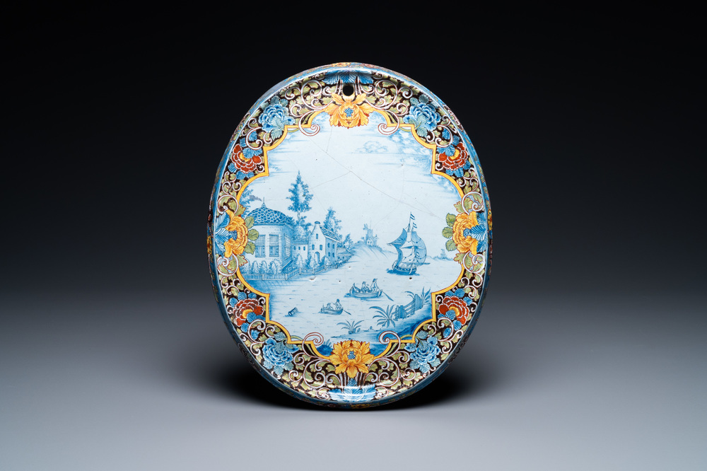 A Dutch Delft black-ground mixed technique oval plaque, 18th C.