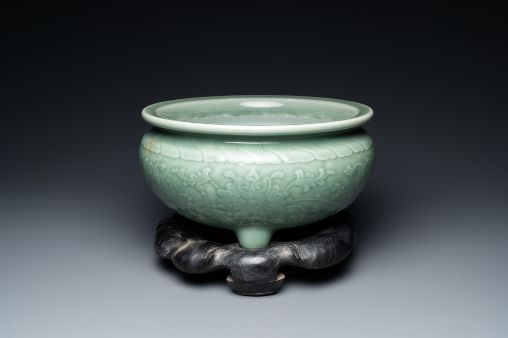 A Chinese celadon-glazed tripod censer with peony scrolls, 18/19th C.