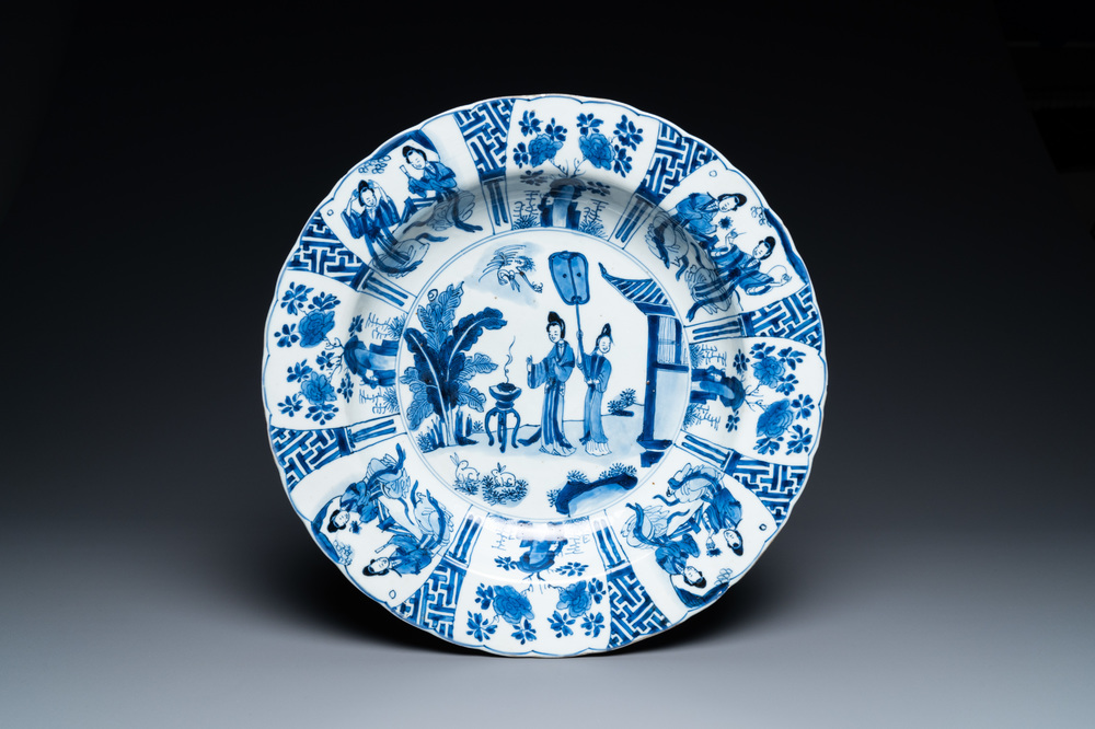 A Chinese blue and white dish with two ladies and two rabbits in a garden, Kangxi mark and of the period