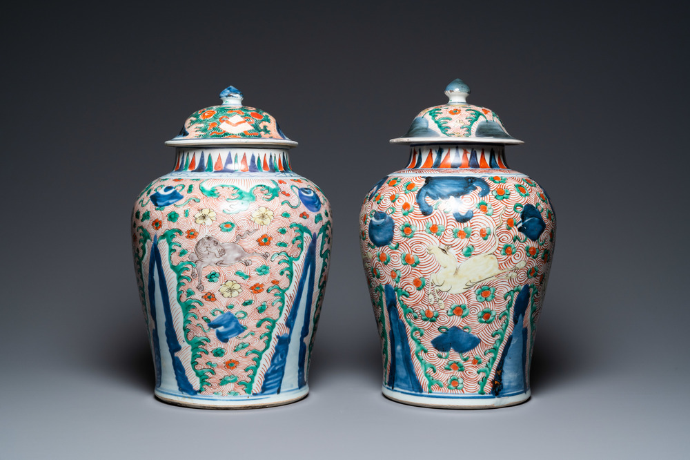 A pair of Chinese wucai 'galloping horses' vases and covers, Transitional period