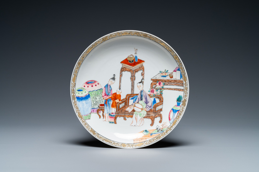 A fine Chinese famille rose plate with a mother, her son and their servant in an interior, Yongzheng