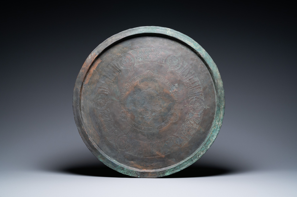 A large Seljuk bronze dish with engraved birds and Kufic inscriptions, Iran, 12/14th C.