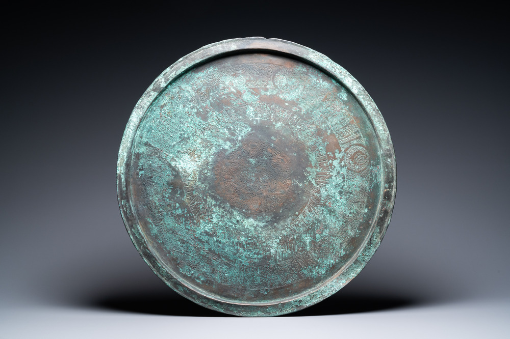 A large Seljuk bronze dish with engraved birds and Kufic inscriptions, Iran, 12/14th C.