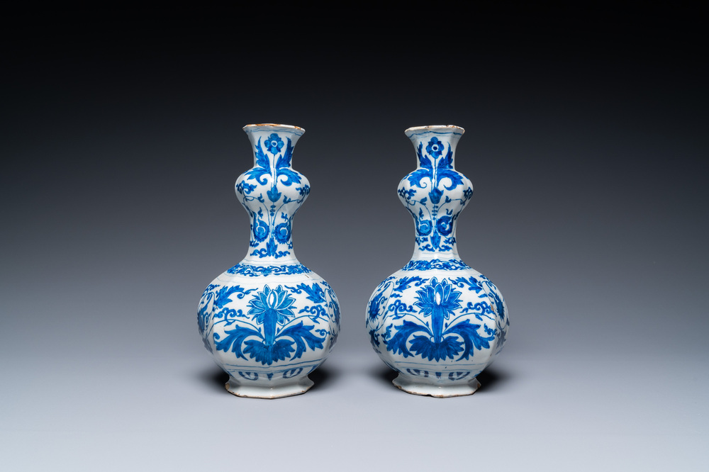 A pair of Dutch Delft blue and white 'garlic head' vases with lotus design, late 17th C.