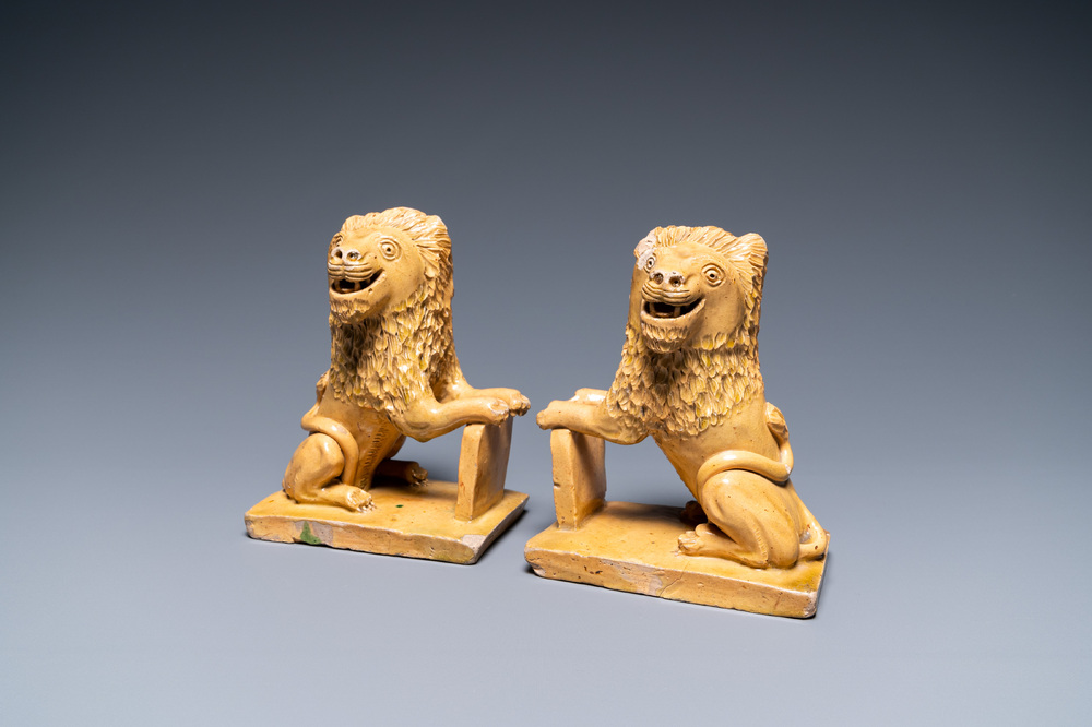 A pair of Flemish or North-French pottery lions, signed and dated 1865