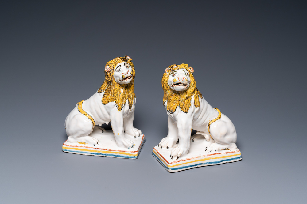 A pair of polychrome French faience lions, Rouen, 1st half 18th C.