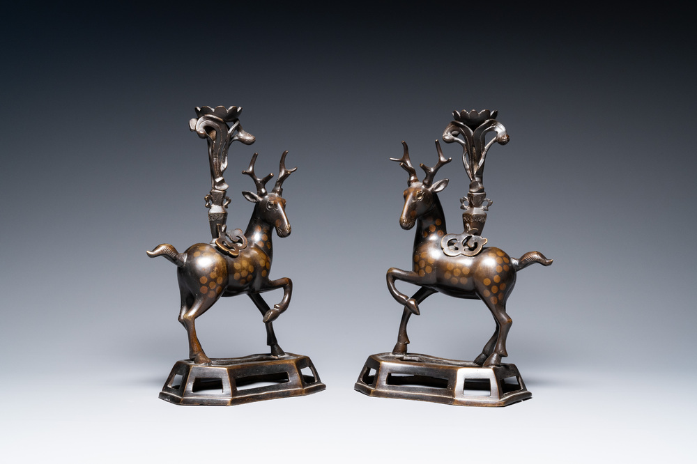 A pair of Chinese bronze deer-shaped candlesticks, Kangxi/Qianlong