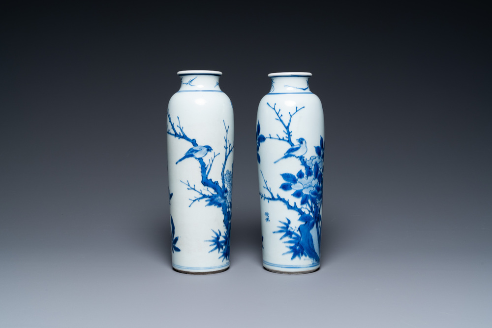 A pair of Chinese blue and white rouleau vases with birds among blossoming branches, Transitional period