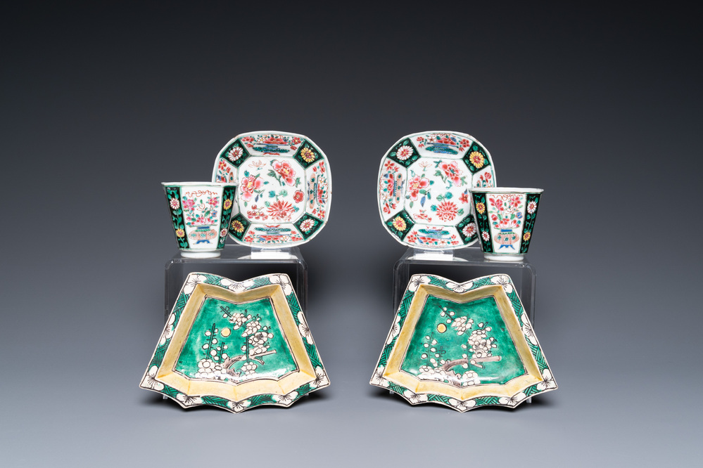 A pair of Chinese octagonal famille rose cups and saucers and a pair of verte biscuit dishes, Kangxi and Qianlong