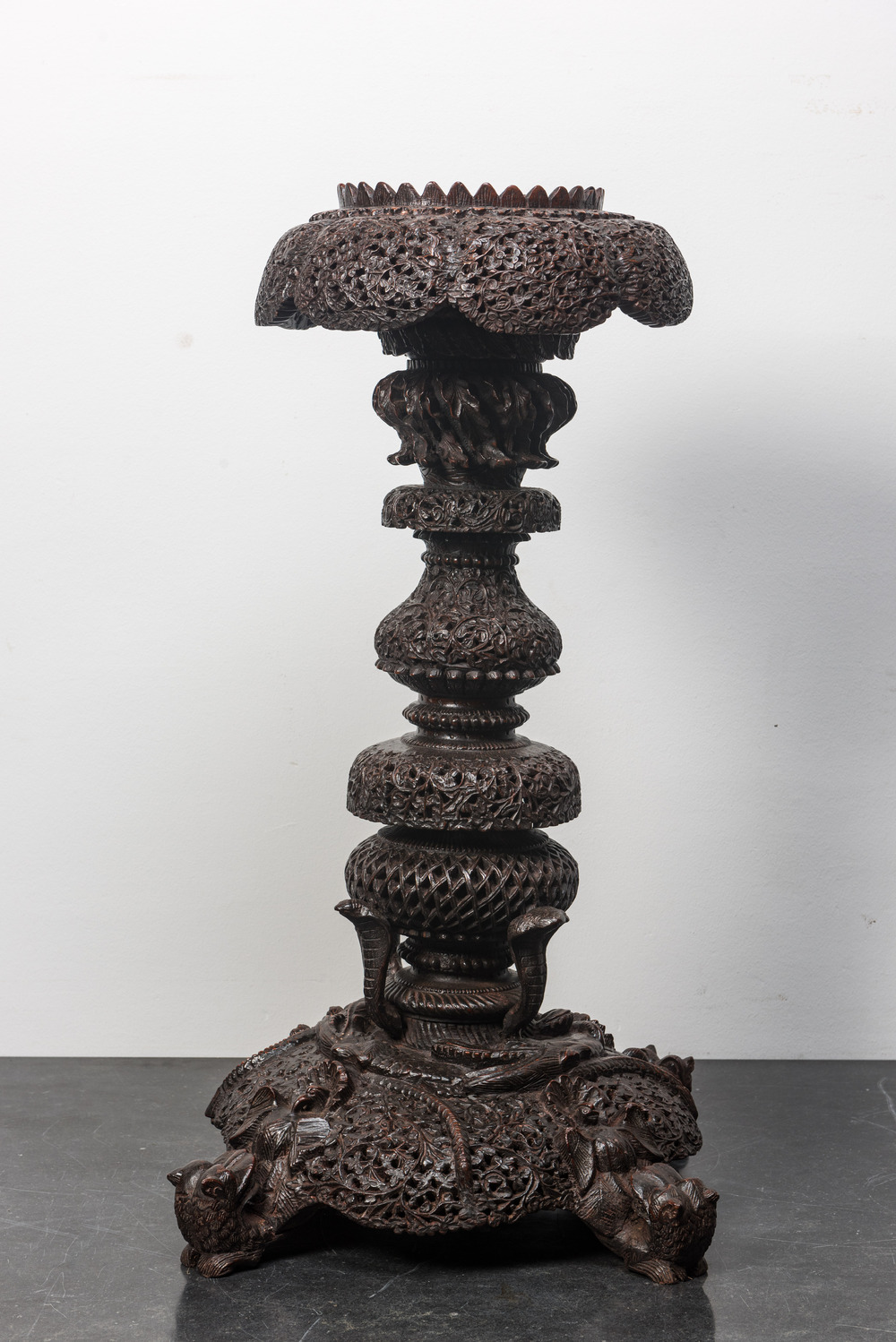 An Anglo-Indian colonial carved wooden plant stand with cobras and floral design, ca. 1900