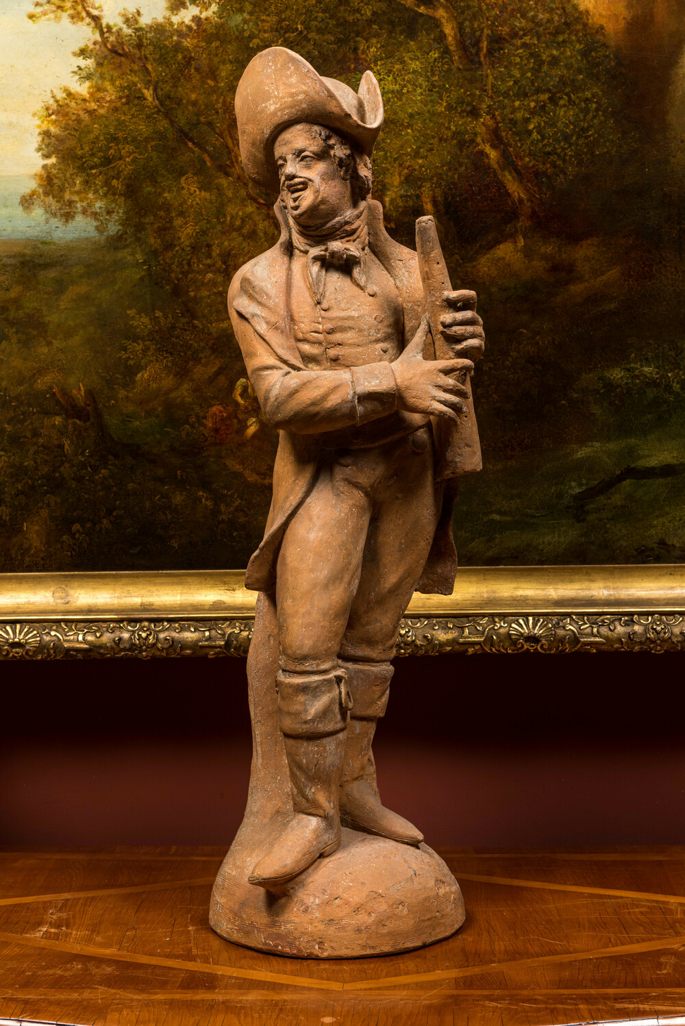 A terracotta figure of a flute player, 19th C.