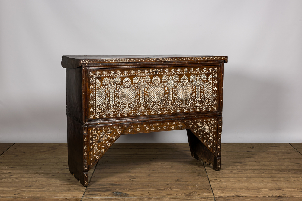 A Syrian mother-of-pearl-inlaid wooden bridal chest on stand, 19th C.