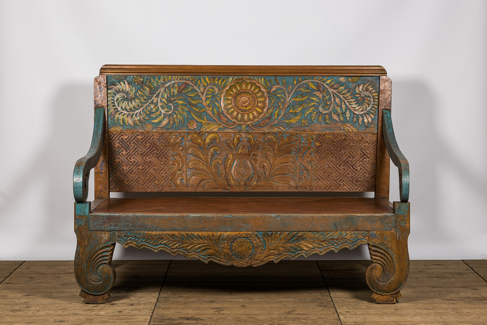 A large Indian polychrome wooden couch with floral design, 20th C.