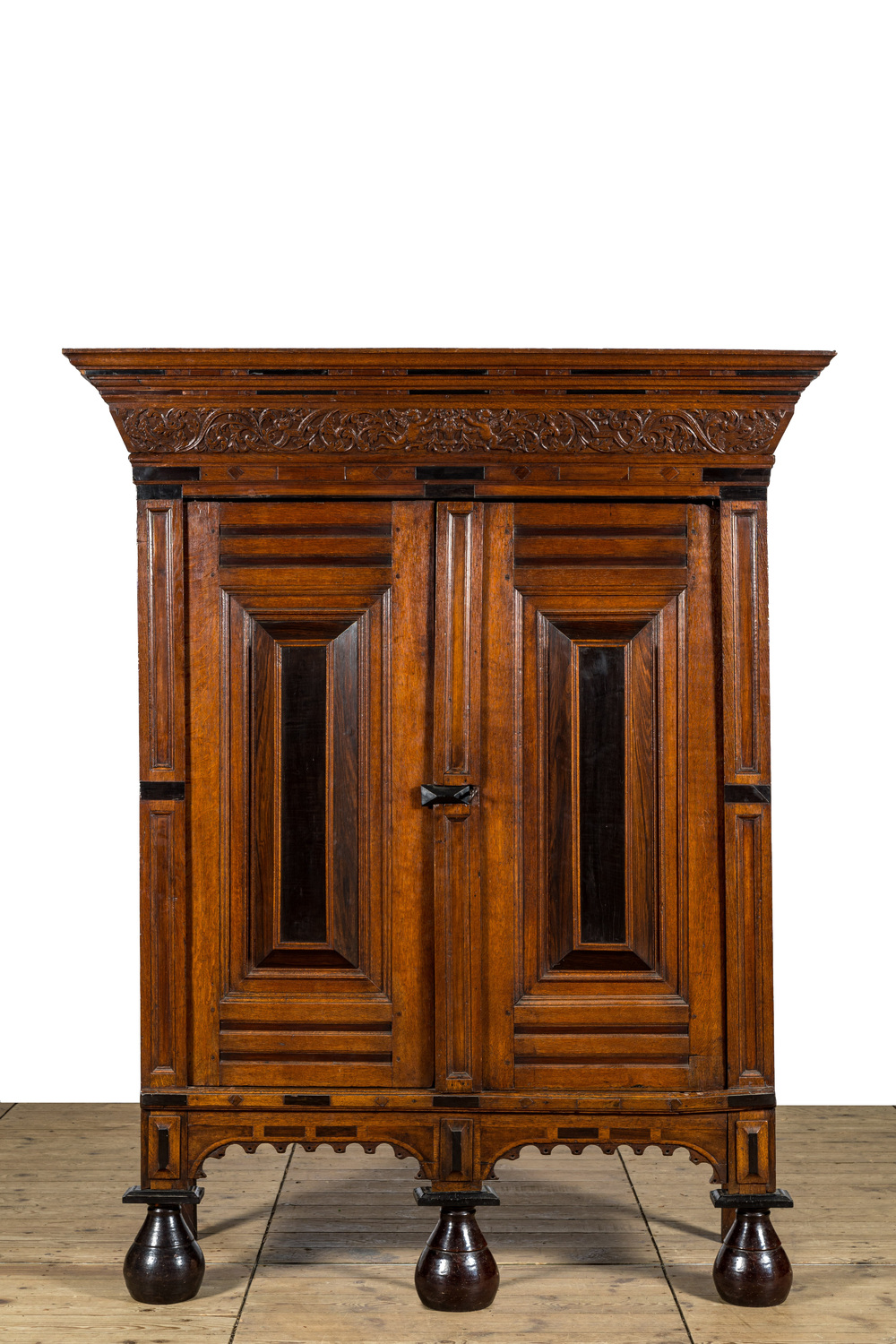 An oak wooden partly ebonised two-door cupboard on black glazed terracotta feet, Holland, 17th C. and later