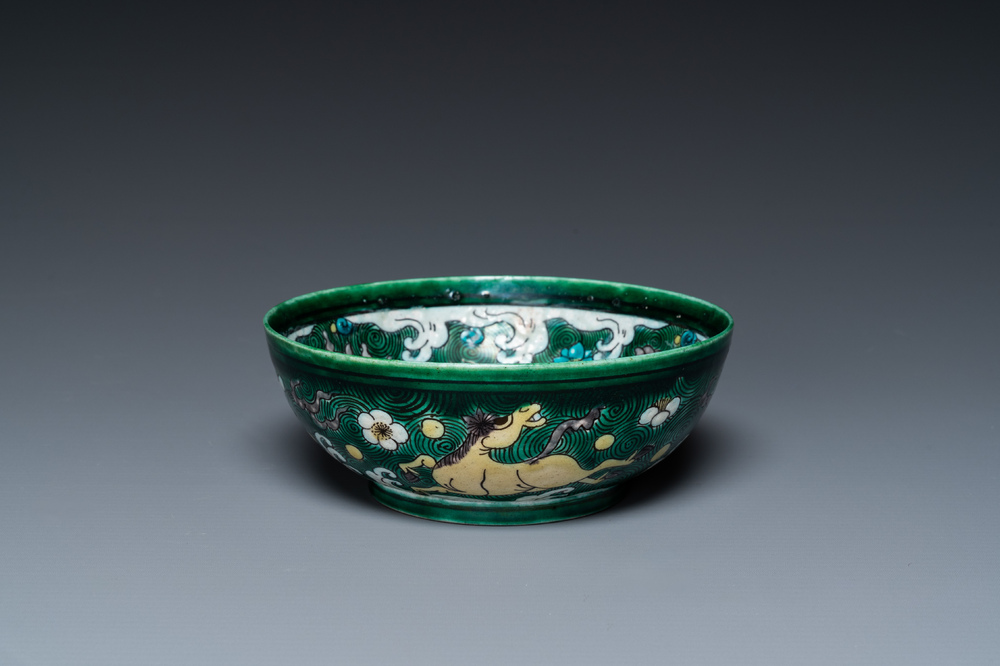 A Chinese verte biscuit 'galloping horses' bowl, Qing