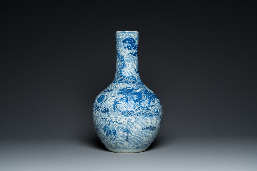 A Chinese blue and white 'dragons' bottle vase, 19th C.