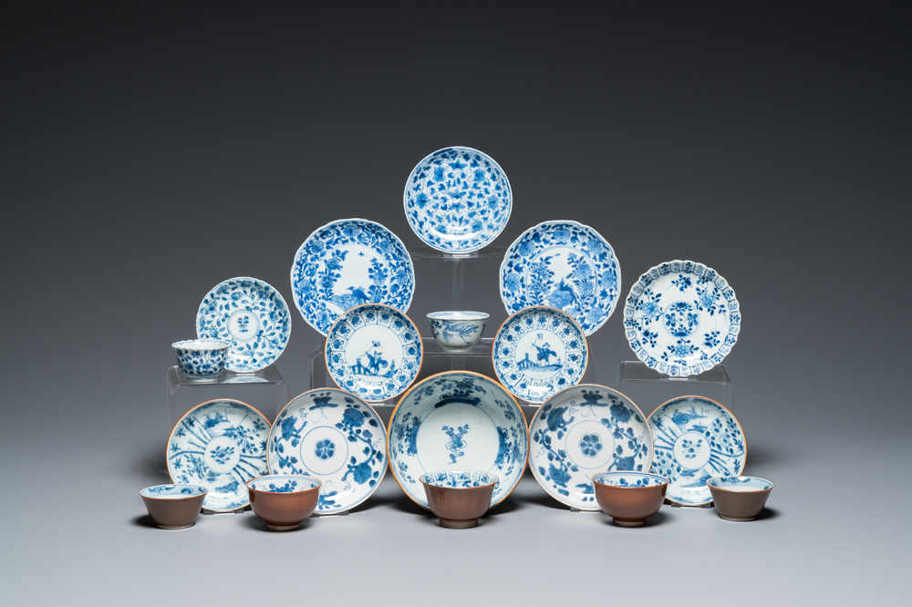 Eleven Chinese blue and white saucers, seven cups and a bowl, Kangxi/Qianlong