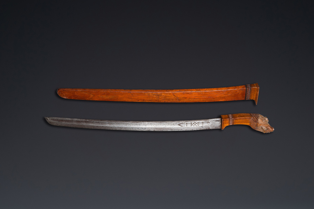 An Indonesian sword in wooden scabbard, dated 1891 and inscribed TJIPATJING